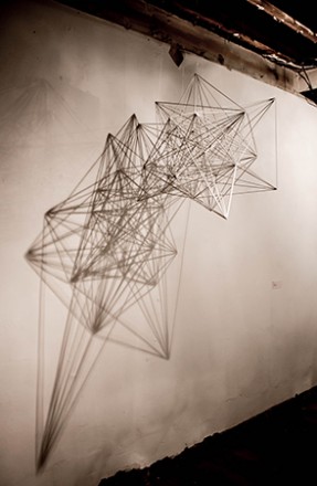 Mona Choo, Between Dimensions, 2012, Wooden rods, glue, light source, approx 65 x 65 x 80 cm